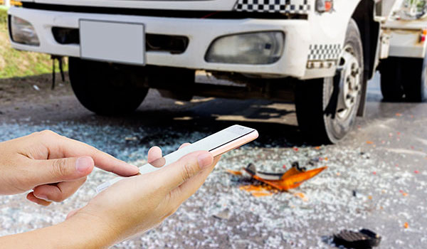 Person conducting a crash investigation using a smart phone RMIS application.