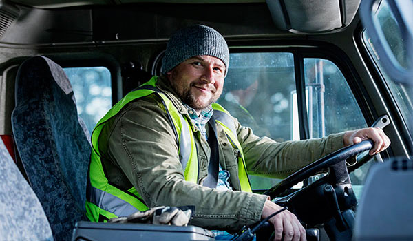 Man with safety vest driving a truck