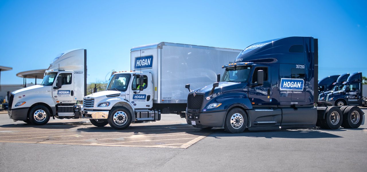 Hogan Transport tractors and trailers staged at a terminal