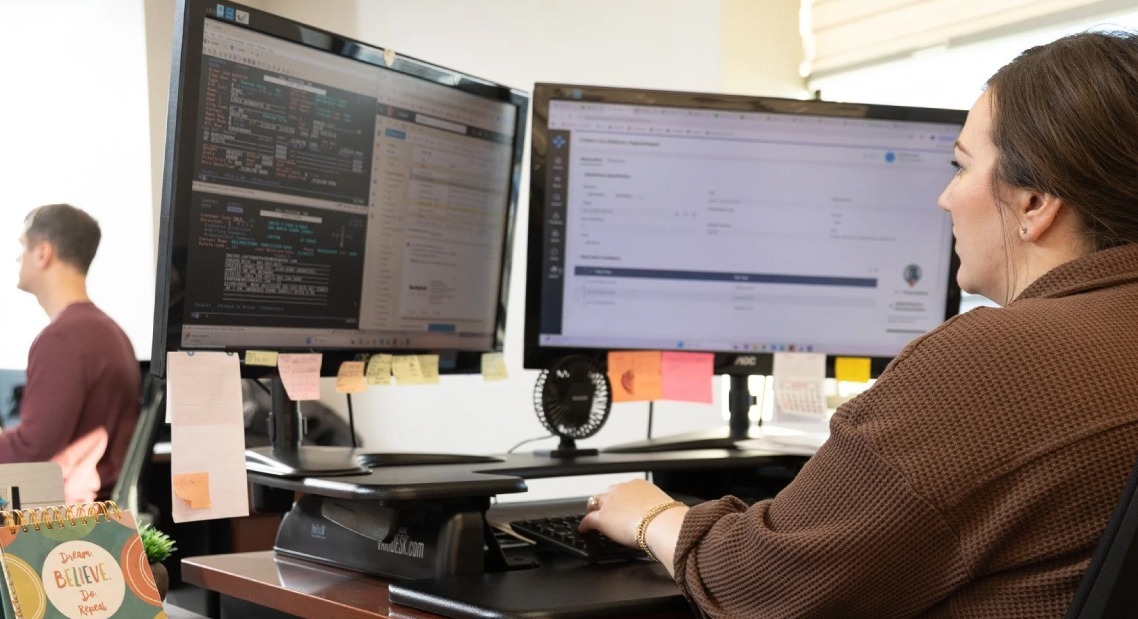 A back-office team working through billing on screen